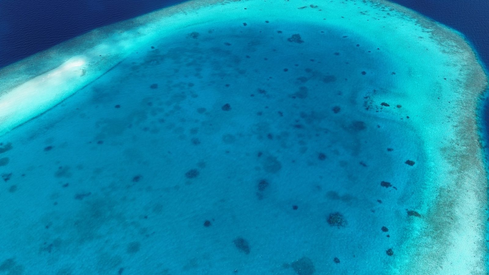 Drone aerial of the lagoon and reef rim at Bobo Lagoon